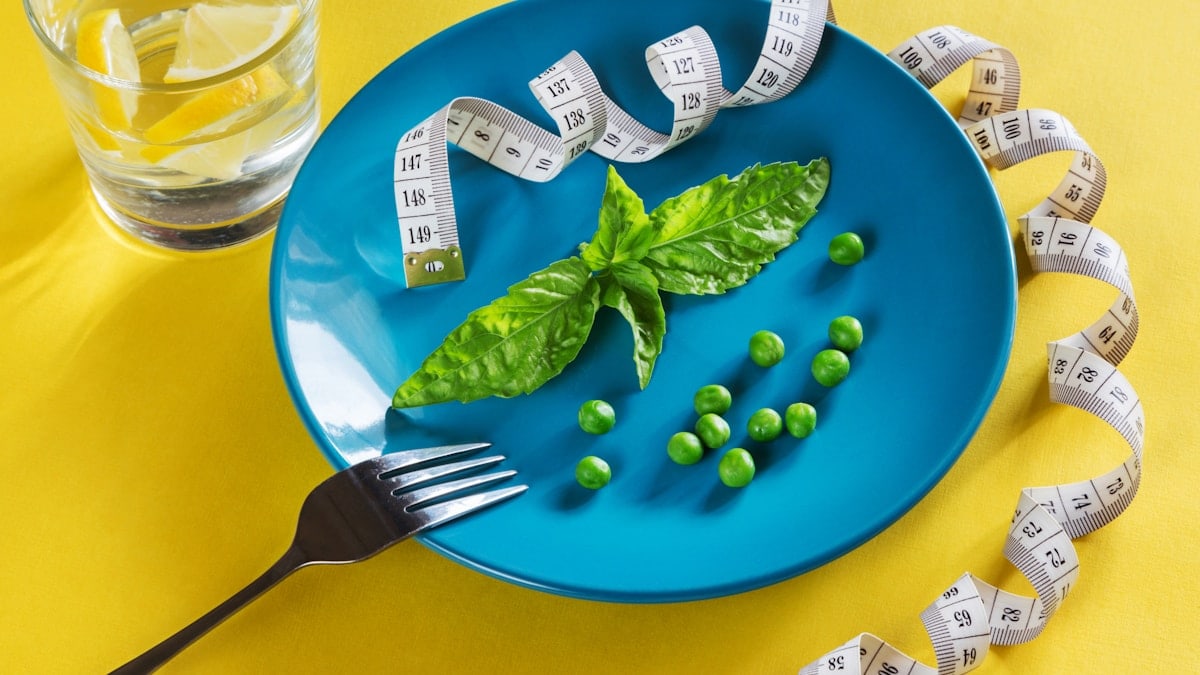 Diet blue plate with centimeter peas and basil